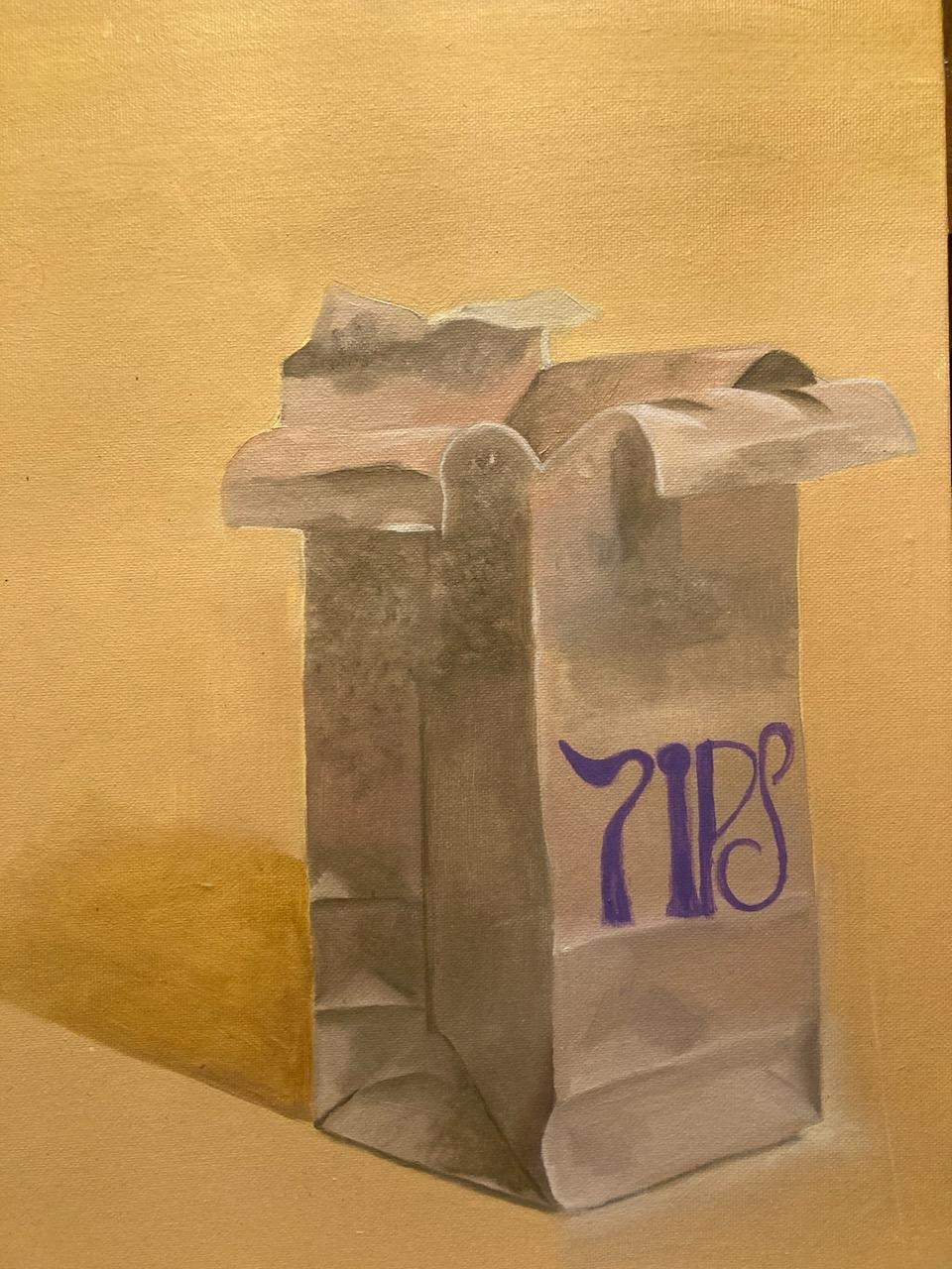 A painted paper bag marked with the word tips